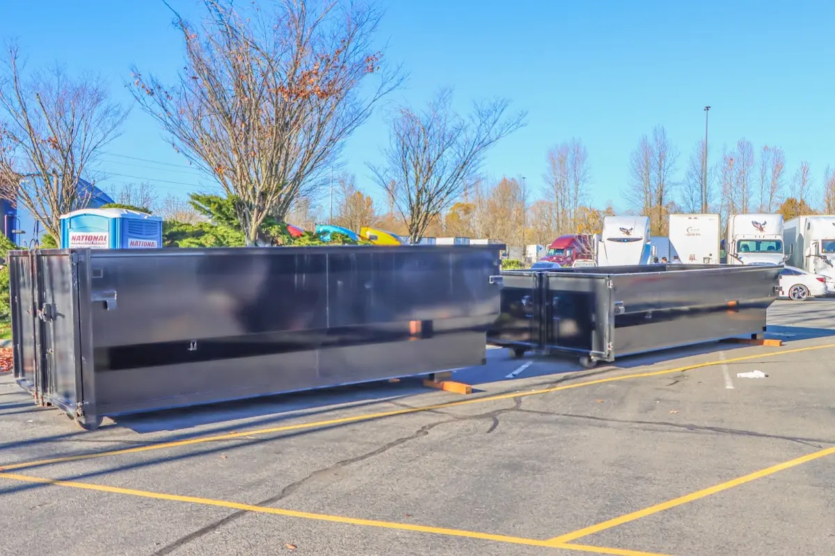 Professional dumpster rental service with roll-off container on residential driveway in Floyds Knobs
